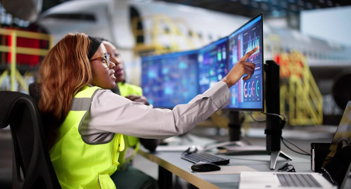 Female aircraft mechanics performing safety checks